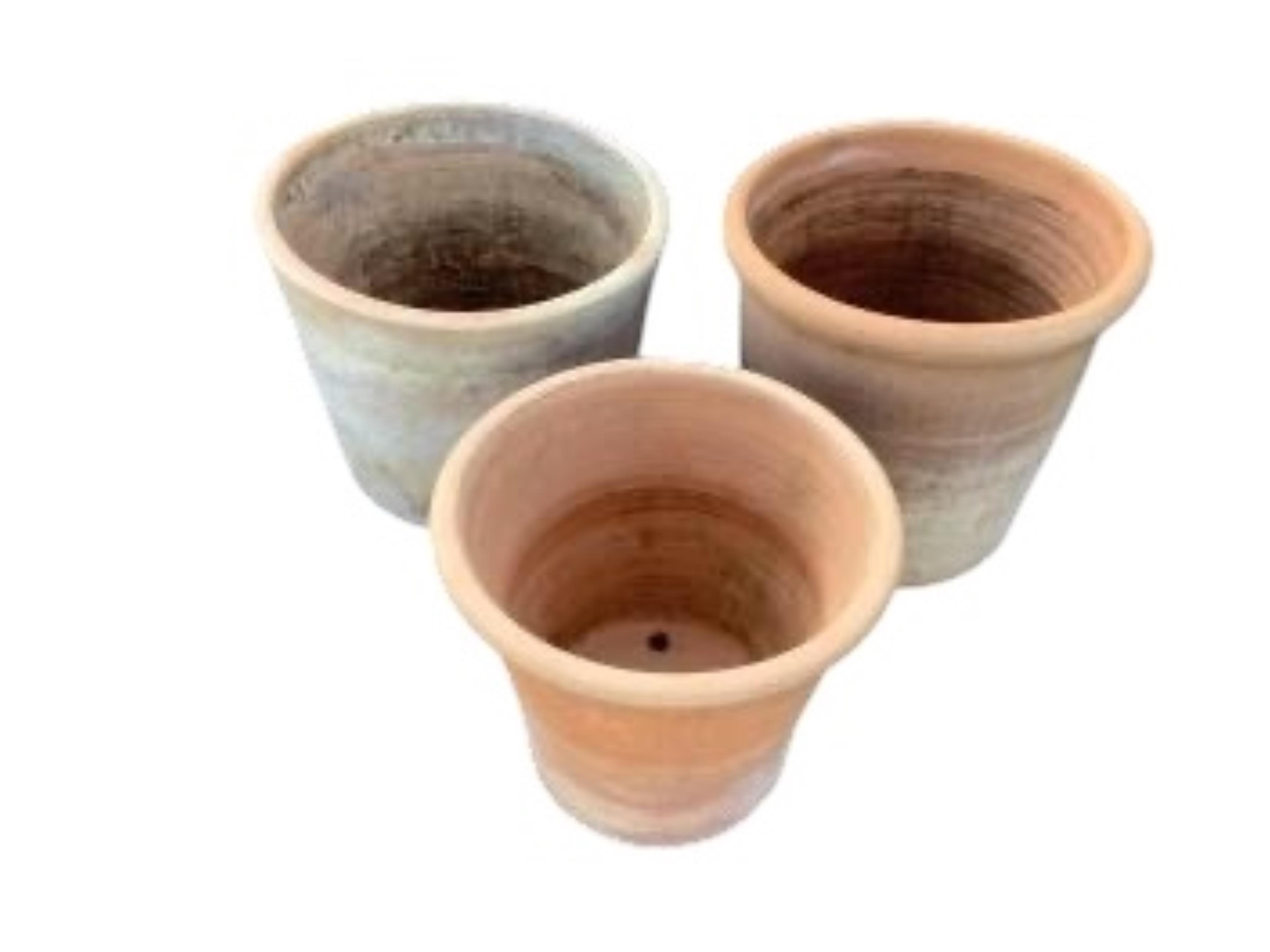 Three circular terracotta garden planters, largest diameter 44cm, height 35cm